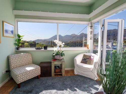 a room with two chairs and a large window at Hendre in Blaenau-Ffestiniog