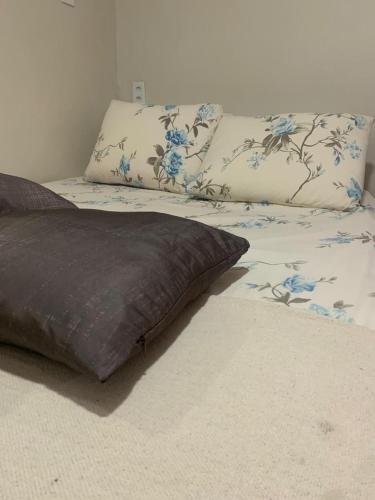 a bed with two pillows on top of it at Residencial Estrela Guia 2 in Cabo Frio