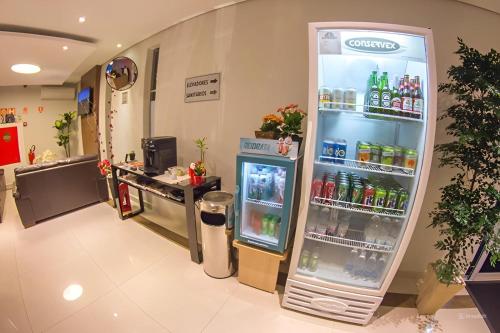 a refrigerator in a store with drinks in it at Hotel Toyo Inn in Boituva