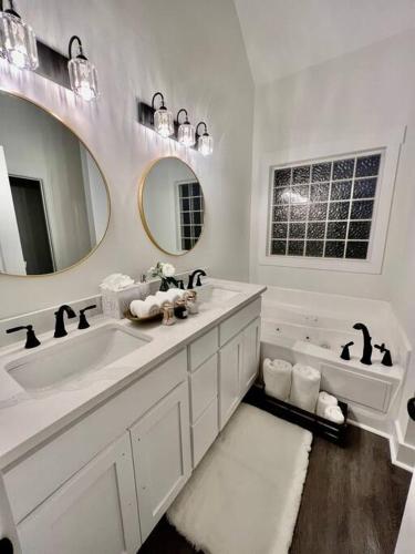 a white bathroom with a sink and a mirror at Lake Lanier House 2 in Gainesville