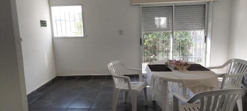 a white dining room with a white table and chairs at Departamento San Pedro, Buenos Aires in San Pedro