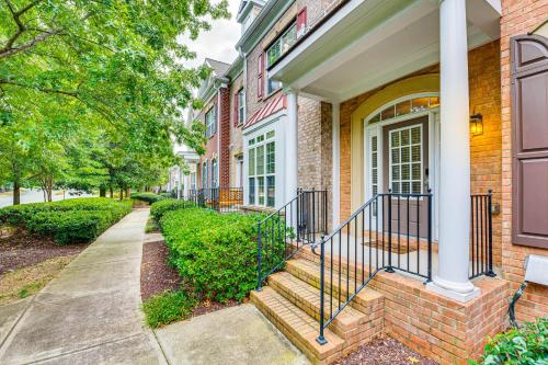 a brick house with stairs leading to the front door at 3 Mi to Avalon Townhome with Balcony in Alpharetta! in Alpharetta
