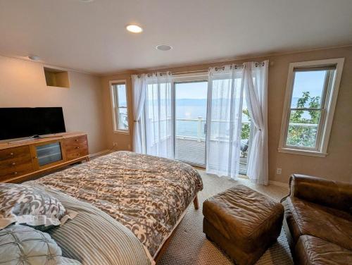 a bedroom with a bed and a large window at Lake Front Retreat on Flathead in Bigfork