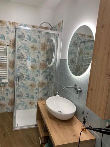 a bathroom with a sink and a shower at SoleMare Rooms Trieste in Trieste