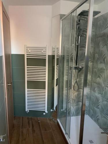 a bathroom with a shower with green and white at SoleMare Rooms Trieste in Trieste