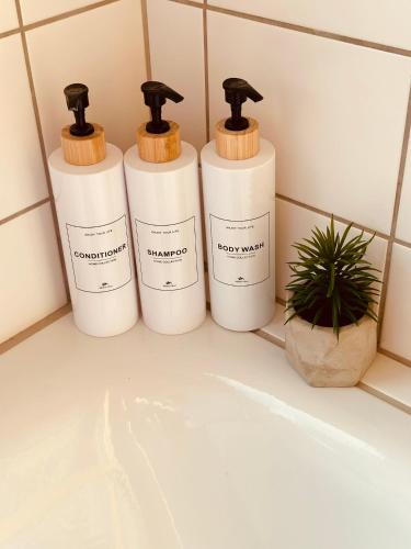 three bottles ofodorizers sitting on a shelf in a bathroom at KA-City, 3 Zi, 75qm, Parken, Balkon, WLAN, Netflix ruhige Lage in Karlsruhe