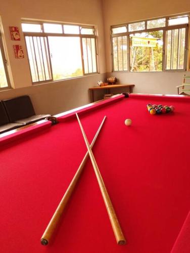 a pool table with two cue balls on top of it at Casa de campo 2qtos região de Extrema in Extrema
