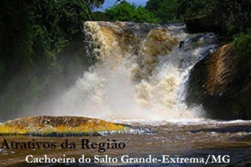 a picture of a waterfall in a river at Casa de campo 2qtos região de Extrema in Extrema