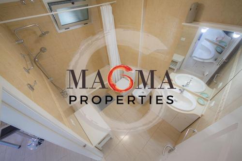 a bathroom with a toilet with the words moca properties at Paradise Golf Holiday House in San Miguel de Abona