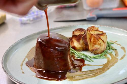 a plate of food with chocolate sauce on it at Boutique Hôtel Château Beaupin Restaurant & Wellness in Marseille