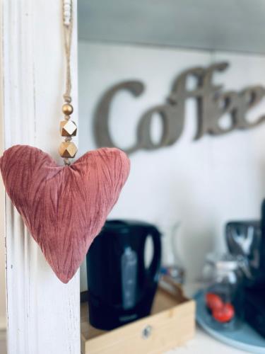 a heart hanging on a door with a coffee sign at Maison de maître 15 personnes in Lierval