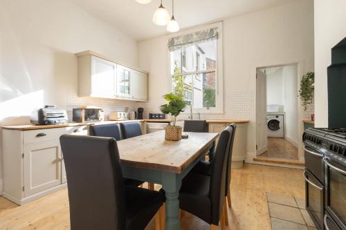 eine Küche mit einem Holztisch und Stühlen in der Unterkunft Host & Stay - Garnet Street in Saltburn-by-the-Sea