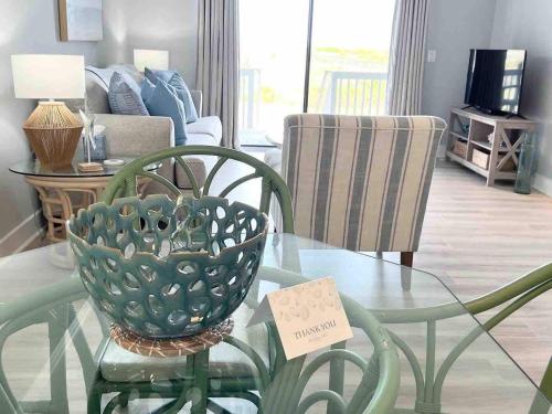 a living room with a glass table and a couch at The Salty Breeze - Ocean Front 1 Bedroom in St. Helena Island
