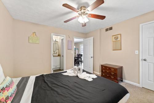 a bedroom with a bed with a ceiling fan at The Conyers Oasis - 10 mins to horse park in Conyers