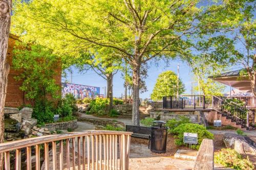 a park with trees and benches and a fence at Private Pool Spacious 5BR Family-Friendly Home in Conyers