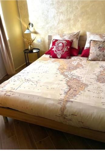 a bed with a map of the world on it at Golden House-Super View On Turin in Turin