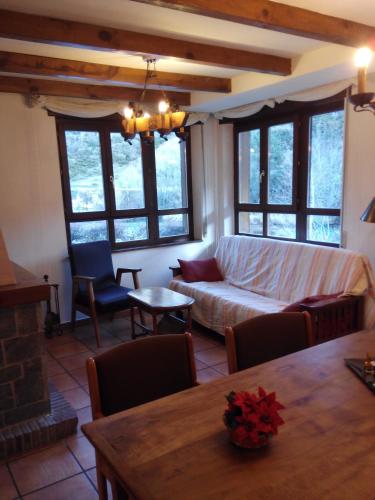 a living room with a couch and a table at El Casar del Puente in Boca de Huérgano