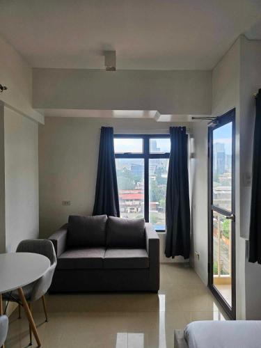 a living room with a couch and a table at Mabolo Garden Flats Bnb in Cebu City
