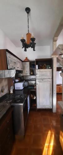 a kitchen with a stove and a stove top oven at Le Chat Riant Deluxe in Fenis