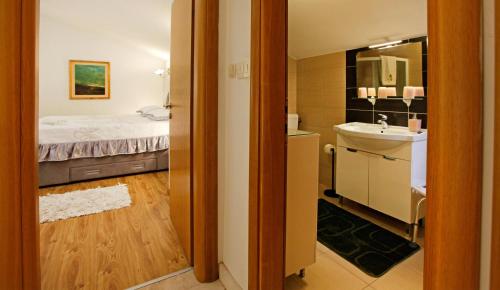 a bathroom with a bed and a sink at Villa Goga in Vela Luka