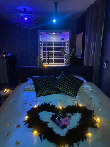 a bedroom with a bed with a heart made out of lights at Love Instant in Chalon-sur-Saône