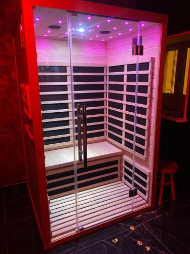 a red refrigerator with a shelf in a room at Love Instant in Chalon-sur-Saône