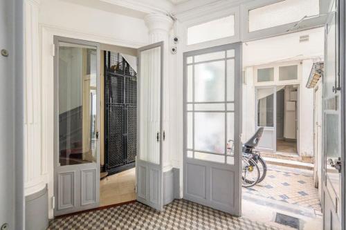 - une chambre avec une porte et un vélo au sol dans l'établissement Apt moderne rénové et spacieux, au cœur de Paris, à Paris