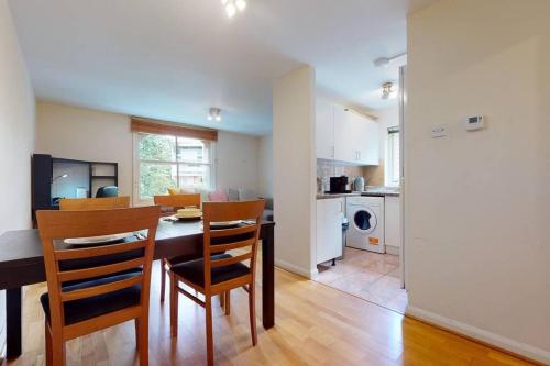 a kitchen and dining room with a table and chairs at -Air Con- Cute 2BD flat 1 Min Maida Vale Station! in London