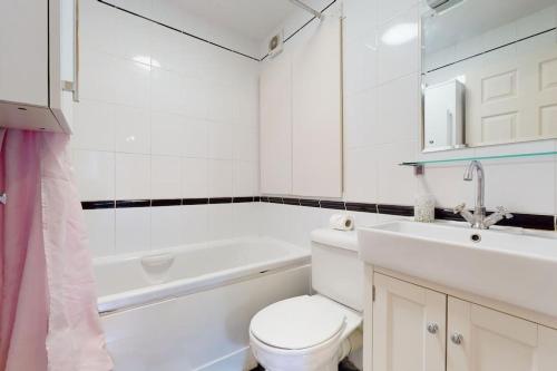 a bathroom with a toilet and a sink and a tub at -Air Con- Cute 2BD flat 1 Min Maida Vale Station! in London