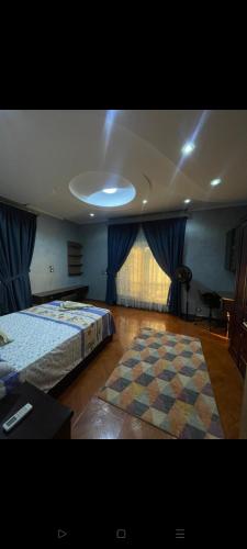 a large bedroom with two beds and a rug at رويل هيلز in 6th Of October