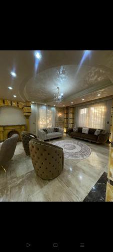 a large living room with two beds and a couch at رويل هيلز in 6th Of October