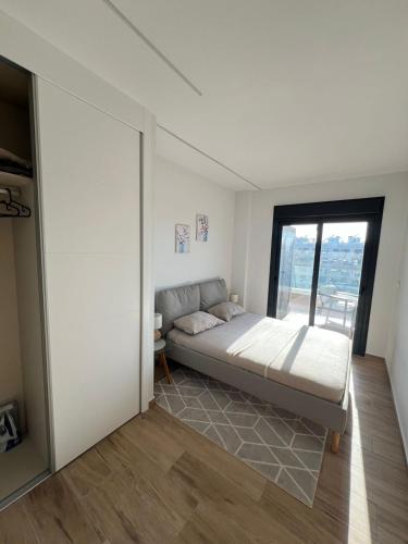 a bedroom with a bed and a large window at Claudia Luxury in Arenales del Sol