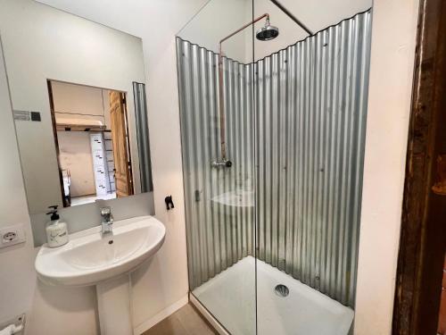 a bathroom with a shower and a sink and a toilet at ECO Hostel in Granada