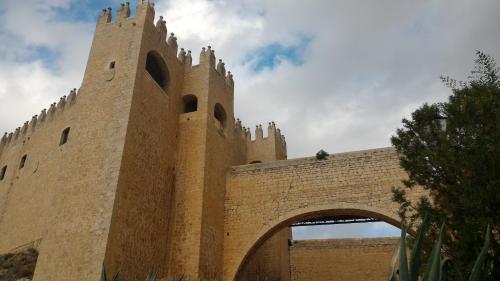 a building with a tower and an arch way at Casa-Cueva Las Colleras in Orce