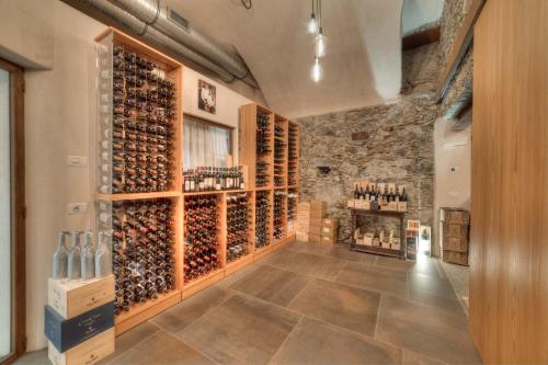 a wine cellar with a large wall of wine bottles at Wine Hotel Ristorante San Carlo - Boutique Hotel & SPA in Chiuro
