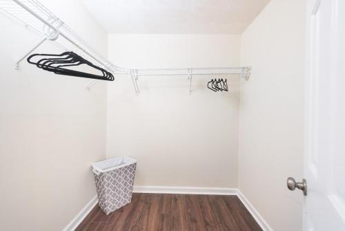 a bathroom with a shower curtain and a wooden floor at The Modern Serenity Townhome -10 mins to Horsepark in Conyers