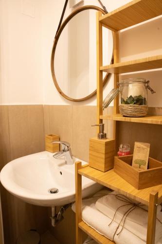 a bathroom with a sink and a mirror at BED and BREAKFAST il Duomo in Ascoli Piceno