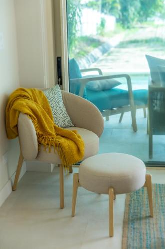 a living room with a couch and a yellow blanket at New Beachfront House - Casa Aura in Santa Teresa Beach
