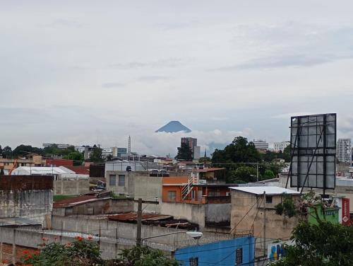 a view of a city with a mountain in the distance at Hostal La Terraza in Lo de Contreras