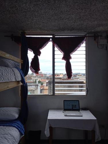 a window with a laptop on a table in a room at Hostal La Terraza in Lo de Contreras