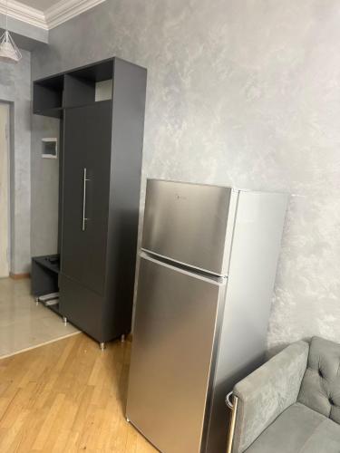 a stainless steel refrigerator in a room with a couch at Zurabyan's Home in Yerevan
