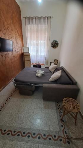 a bedroom with a large bed and a window at Casa Gioele in Siracusa