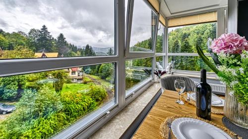 a kitchen with a table and a window with a view at Apartament 26 Resort Kozubnik blisko Szczyrk - 5D Apartamenty in Porąbka