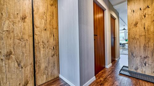 a hallway with wooden walls and wooden floors at Apartament 26 Resort Kozubnik blisko Szczyrk - 5D Apartamenty in Porąbka