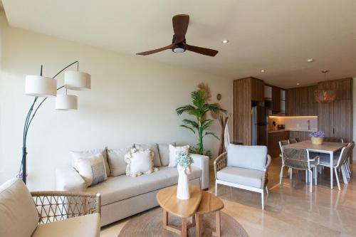 a living room with a couch and a table at Beachfront Condo, Zantamar 305 in Cruz de Huanacaxtle