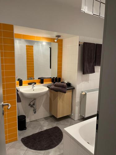 a bathroom with a sink and a bath tub at Hinter der Alten Post in Annaberg-Buchholz