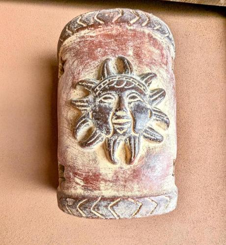 a stone relief of a sun on a wall at Hotel Mar y Mar in Puntarenas
