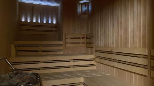 a room with wooden walls and benches in a building at Centrum Slezská Harta in Razová