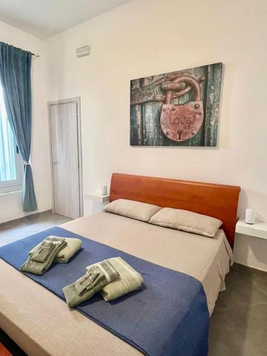 a bedroom with a bed with two towels on it at Gens Fulvia Brindisi in Brindisi