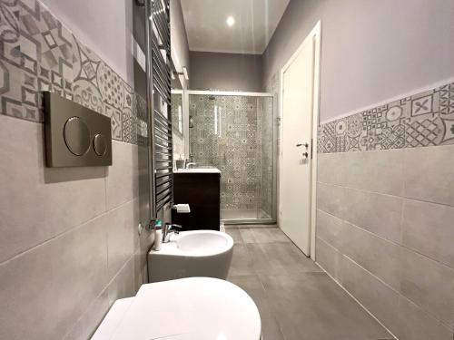 a bathroom with a toilet and a sink and a shower at Italy Vacation Rental in Trieste